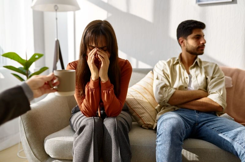 Couple in therapy, with one individual showing emotional distress, while the other remains distant, highlighting the importance of treatment for antisocial personality disorder in relationships