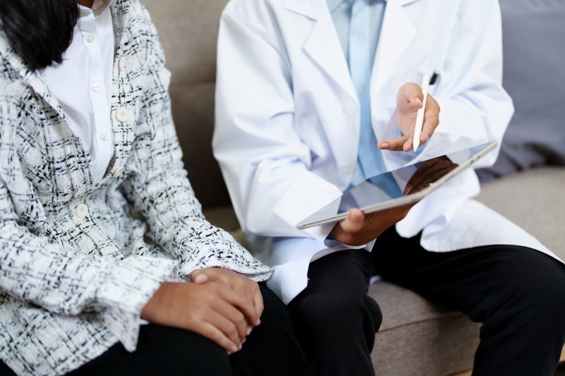 Anxiety specialist discussing treatment options with a patient, showing a consultation in a comfortable setting.