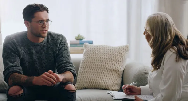 Man in a mental health appointment talking with a therapist during a session