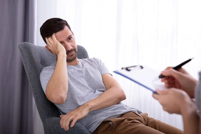 Individual looking distressed during therapy at one of the best treatment facilities for borderline personality disorder, highlighting the importance of specialized care