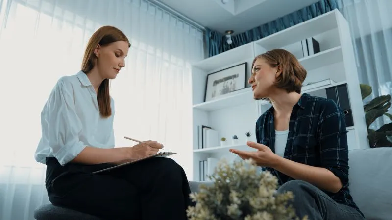 A woman speaking with a therapist during a psychiatric telemedicine session, focusing on personalized mental health care through telemedicine services