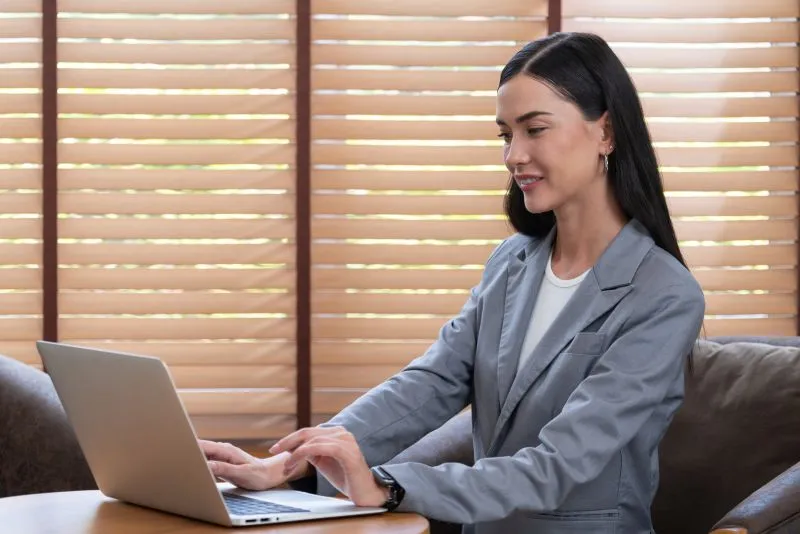 A professional engaging in telepsychiatry services on a laptop, offering remote mental health consultations as a part of modern therapy options.