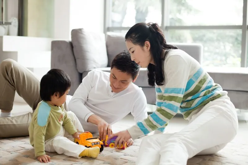 A family playing together at home, creating positive experiences and emotional connections that support mental wellness through family first counseling and psychiatry.