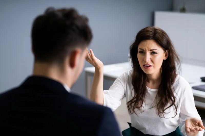 A woman in a therapy session discussing her emotions, exploring mental health and psychiatric care with the support of a mental health nurse practitioner.