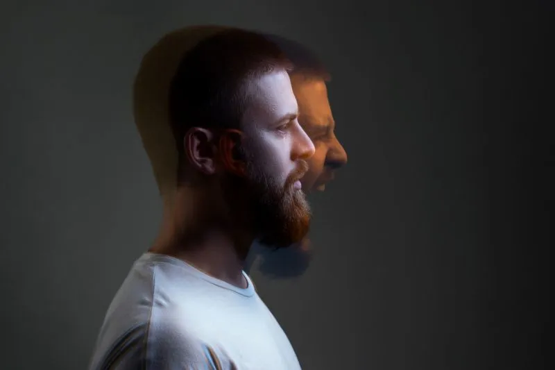 A man with a blurred expression, representing the fragmented states of mind that individuals with dissociative identity disorder may experience. Therapy and trauma-focused interventions are essential treatments for this condition.