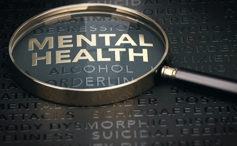 A magnifying glass focusing on the words 'Mental Health,' surrounded by various mental health terms like 'depression,' 'anxiety,' and 'suicidal thoughts.' This highlights the complexity of mental health issues and the role of mental health residential treatment in providing specialized care.