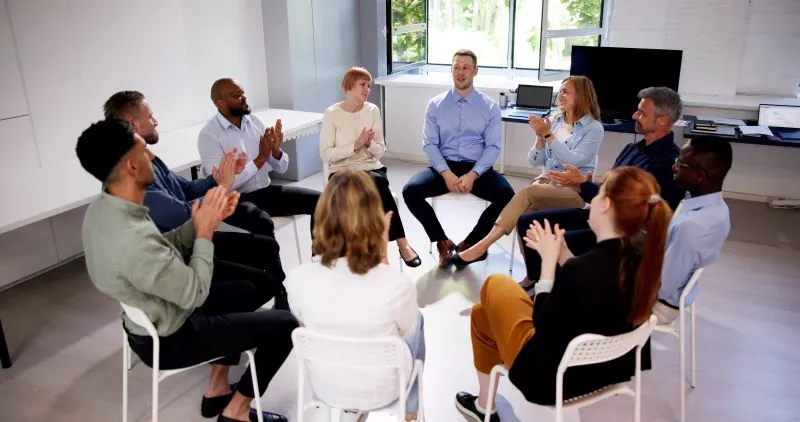 Group therapy for mental health: A diverse group of individuals engaging in a therapeutic session, working together for emotional growth.