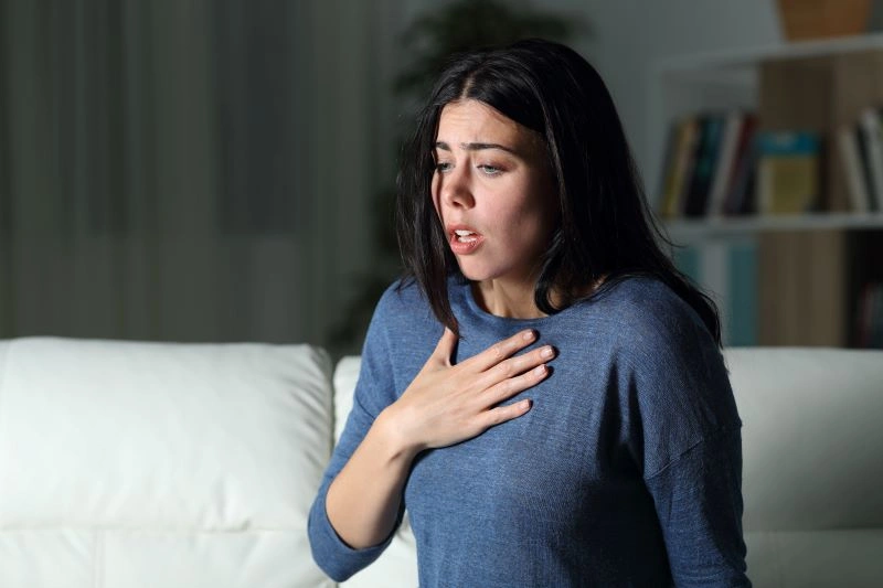 Cognitive Behavioral Therapy for General Anxiety Disorder: A woman showing signs of anxiety, with CBT being an effective treatment for reducing such symptoms.