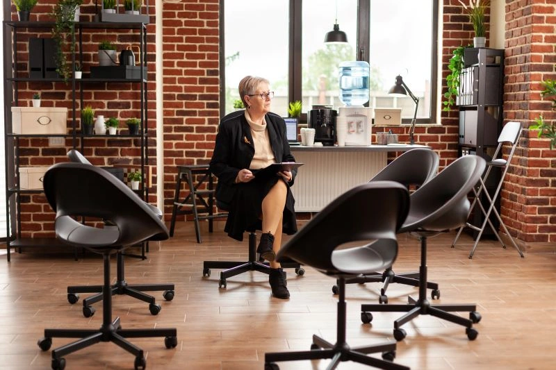 A rehab specialist waiting in a counseling room, ready to assist individuals with mental health or addiction recovery.