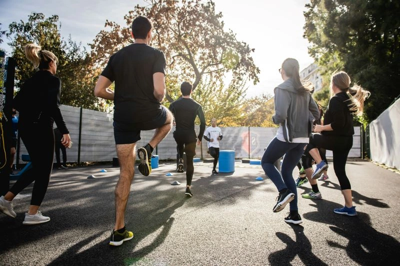 A group of individuals participating in a running session outdoors, showcasing how physical activity like running can boost mood and enhance mental well-being.