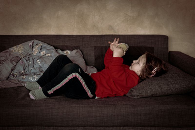 Child resting on a couch before an ADHD assessment for child