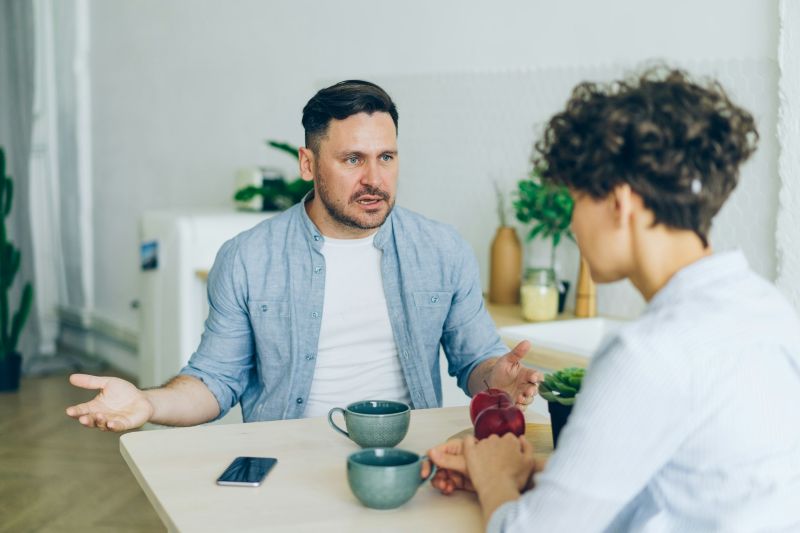 Couples therapy for communication issues in a counseling setting where a man discusses concerns with a therapist during a guided conversation
