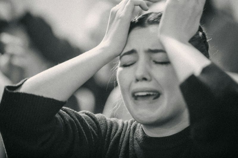 Person showing signs of emotional overwhelm often associated with ADHD and social anxiety.