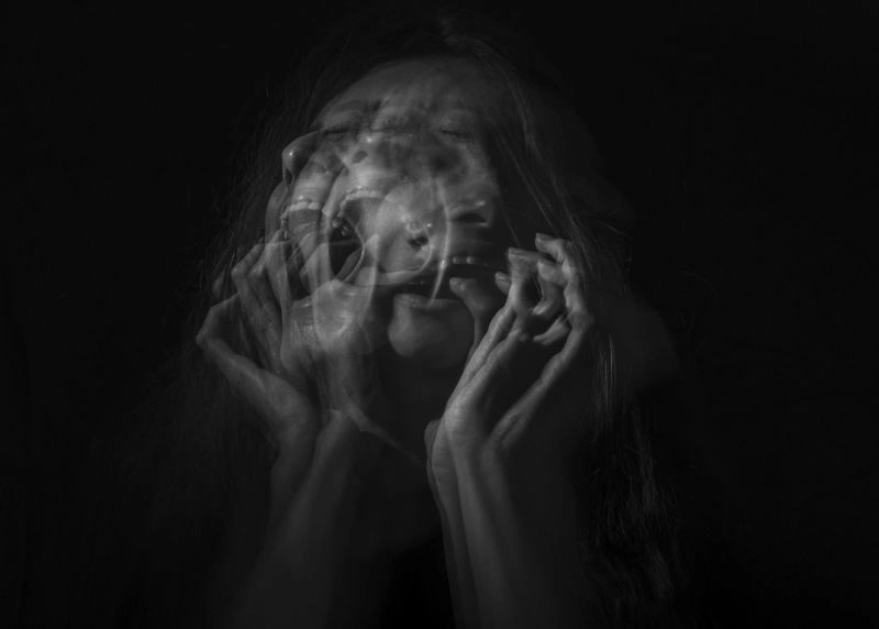 Person experiencing blurred emotions and distress, illustrating the effects of emotional numbness.