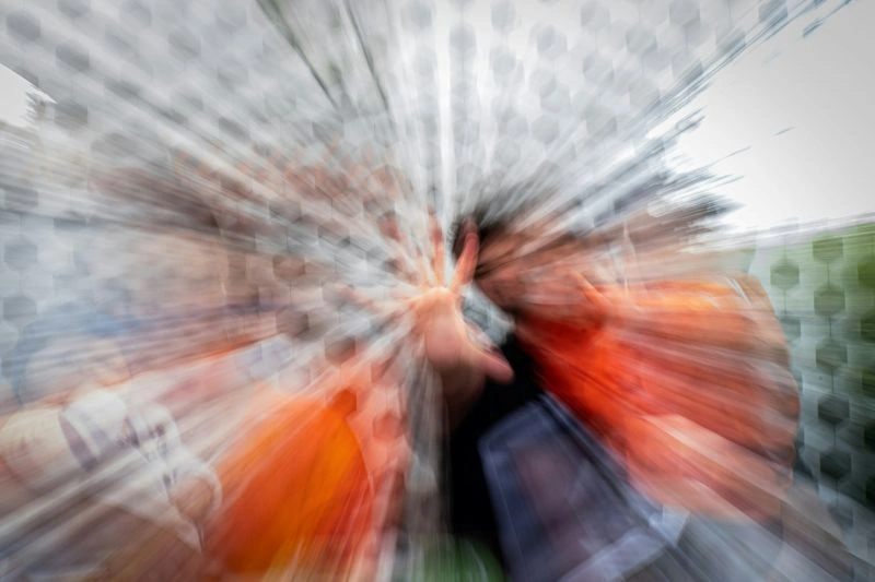 Person experiencing intense distress with hands over their ears, illustrating symptoms related to panic attack vs anxiety attack.