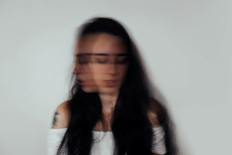 Blurred portrait of a person reflecting on existential anxiety and feelings of uncertainty