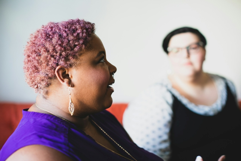 Woman speaking during a group discussion, illustrating communication and social experiences associated with high functioning ADHD.