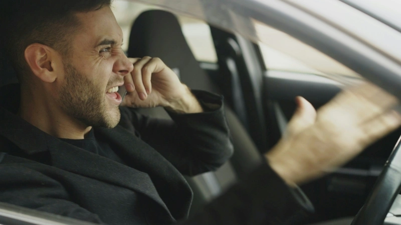 Angry man gesturing while sitting in a car, reflecting frustration and emotional tension associated with why am I so irritable.
